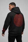 Model wearing Aztec calendar hoodie from behind showing back design and cuffs